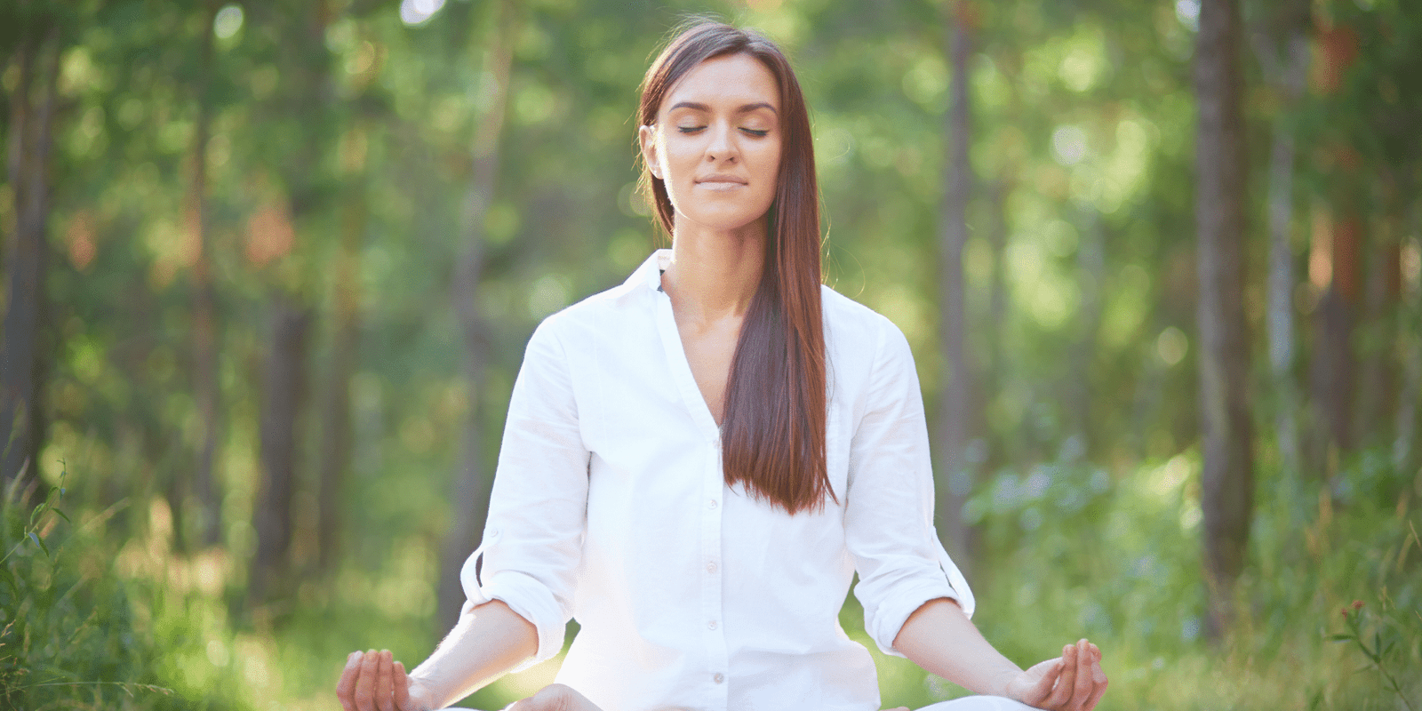 Woman practicing meditation in nature for inner peace and mindfulness